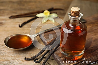 Aromatic homemade vanilla extract on wooden table. Space for text Stock Photo