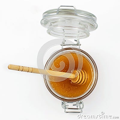 Aromatic honey with dipper into jar isolated on white background. Top view Stock Photo