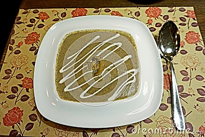 Aromatic mushroom soup made of champignons in a white porcelain dish. Stock Photo