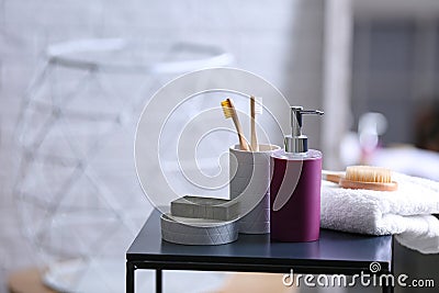 Aromatic soap and toiletries on table against blurred background. Stock Photo