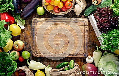 Around the kitchen board abundance healthy food on wooden table Stock Photo