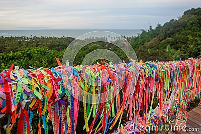 Arraial Dajuda, Bahia, Brazil: colorful souvenir ribbons hanging on the railing, sea on background Editorial Stock Photo