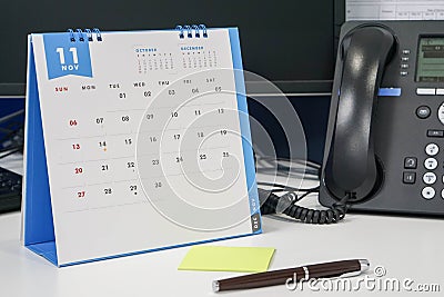 Arrange November meeting on calendar with phone discussion Stock Photo