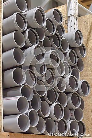 Arranged heap plastic pipes, grey shelf sold store Stock Photo