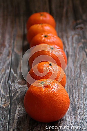 Arranged in a row of mandarin, orange citrus fruit, juicy fruit full of vitamins, tangerine cut in half Stock Photo