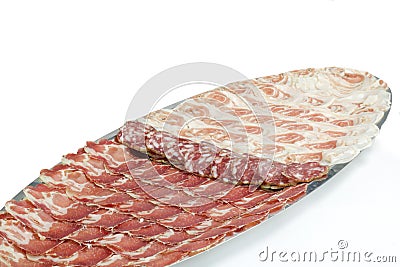 arrangement of delicatessen meat in a long tray on white background Stock Photo