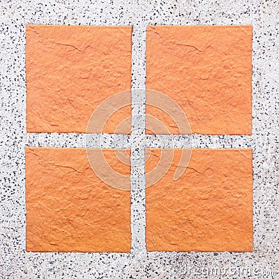 An Arrangement of four tiles on pebble background Stock Photo