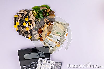 Arrangement of herbal medicines, money notes and calculator on a white background. Healthcare concept Stock Photo