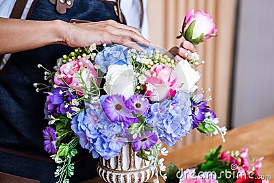 Arranging artificial flowers vest decoration at home, Young woman florist work making organizing diy artificial flower, craft and Stock Photo