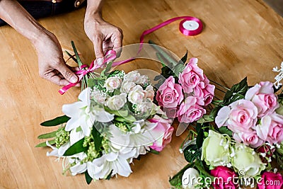 Arranging artificial flowers vest decoration at home, Young woman florist work making organizing diy artificial flower, craft and Stock Photo