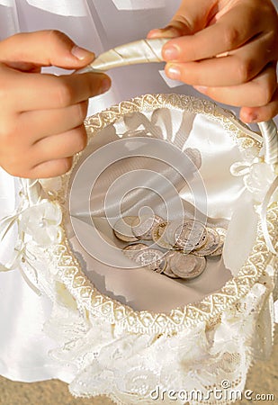 Arras, close up view of pesetas, old Spanish coins that are used symbolically in the celebration of a religious wedding in Spain. Stock Photo