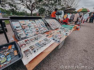 Array of colorful toy cars arranged in a neat line in an outdoor market in Bangi, Malaysia Editorial Stock Photo