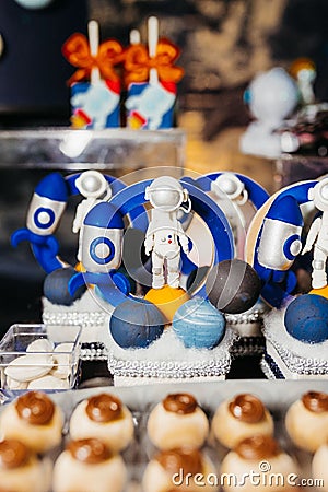 Array of cupcakes decorated with small astronaut figures Stock Photo
