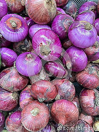 Array of purple onions displayed in the market, ready for purchase Stock Photo