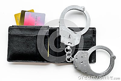 Arrest of cybercriminals, hackers concept. Handcuff near bank card on white background top view Stock Photo