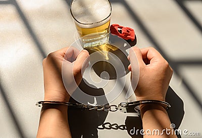 arrested drunk driver in jail with handcuffs Stock Photo