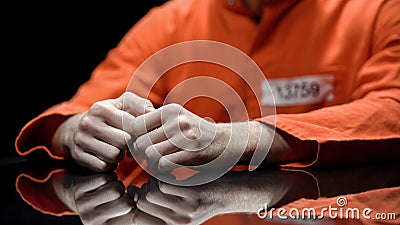 Arrested person hands closeup, prisoner talking to lawyer during interrogation Editorial Stock Photo
