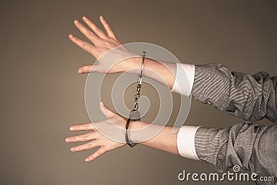 Criminal hands locked in handcuffs Stock Photo