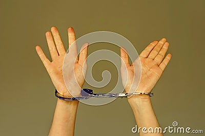 Criminal hands locked in handcuffs Stock Photo