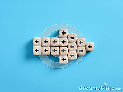 Arrow icon made of wooden cubes with little arrow icons pointing opposite direction. Resistance to change in business Stock Photo