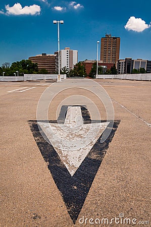 Arrow in parking lot and view of highrises from a parking garage Stock Photo