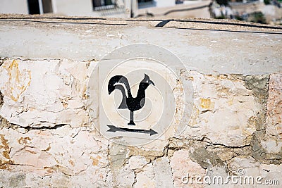 Arrow pointer with black cock on the way to Church of Saint Peter in Gallicantu, located on Mount Zion, Jerusalem, Israel Stock Photo