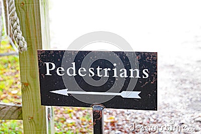 An arrow on a sign points the way for pedestrians Stock Photo