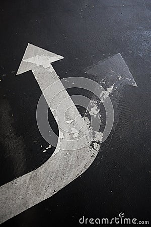 Arrow signage on an asphalt road indicating a detour Stock Photo