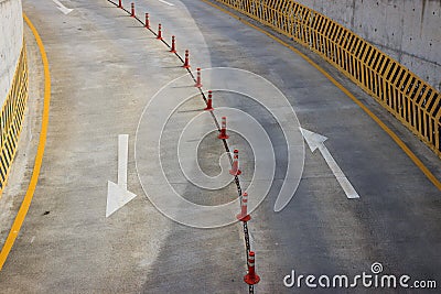 Arrow symbols and bollards on road Stock Photo