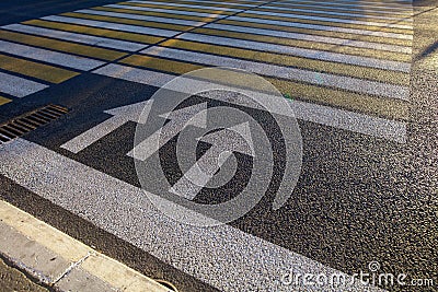 Arrows on the asphalt on the pedestrian crossing Stock Photo