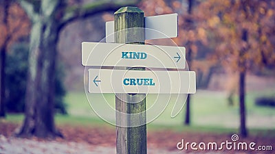 Arrows pointing two opposite directions towards Kind and Cruel Stock Photo