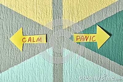 Arrows with text PANIC and CALM on color background Stock Photo