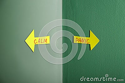 Arrows with text PANIC and CALM on color background Stock Photo