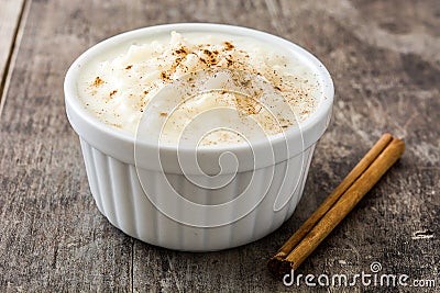 Arroz con leche. Rice pudding with cinnamon on wood Stock Photo
