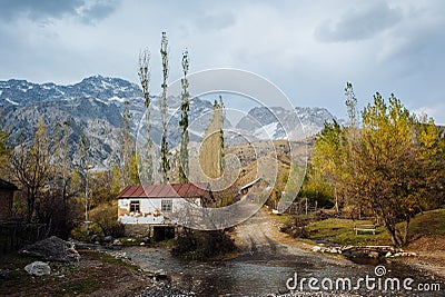 ARSLANBOB, KYRGYZSTAN: View of Arslanbob village in southern Kyrgyzstan, with mountains in the background during autumn. Stock Photo