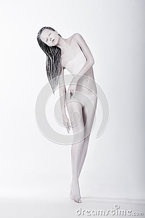 Art Bodypainting. Silhouette of Enigmatic Stylized Female Painted White Stock Photo