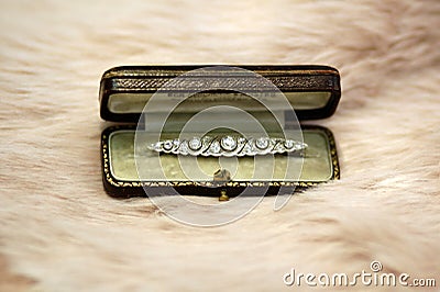 Art deco diamond brooch in box on dusty rose fur Stock Photo