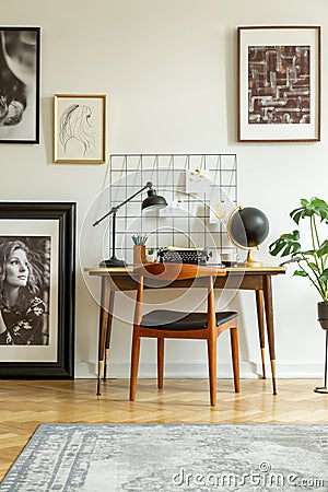 Art gallery in a retro home office interior with a desk and chair. Real photo Stock Photo