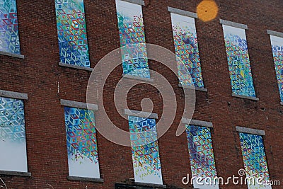 art mural windows on a brick factory building, closed down, boarded up Editorial Stock Photo