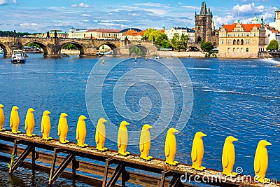 Art object march of yellow penguins. Weird art statues of Prague Editorial Stock Photo