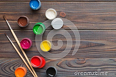 art palette with paint and brushes, close up. Top view with empty space. workplace for creativity. home teaching concept Stock Photo