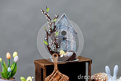 Art pastry chef, chocolate birdhouse with eggs and nest, spring dessert Stock Photo