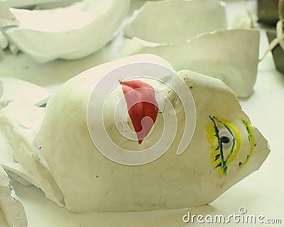 Art school still life with plaster face head and broken plaster pieces Stock Photo