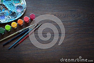 Art set, palette, paint, brushes on wooden background. Stock Photo