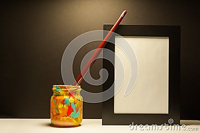 Art supplies brush and black frame in dramatic light with black background Stock Photo