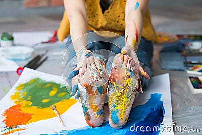 Art therapy feet hands dirty multicolor paint Stock Photo