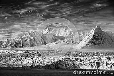 Art view on winter Arctic. White snowy mountain, blue glacier Svalbard, Norway. Ice in ocean. Iceberg in North pole. Global warmin Stock Photo