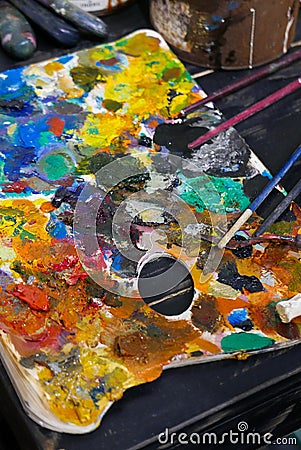 Art work shop color Palette with brushes. Stock Photo