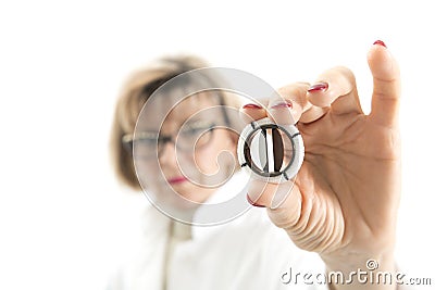 Arteficial heart valve in a hand of a female doctor Stock Photo