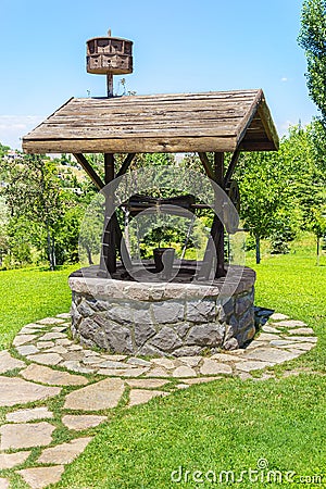 Artesian Water Well With Pulley and Bucket Stock Photo